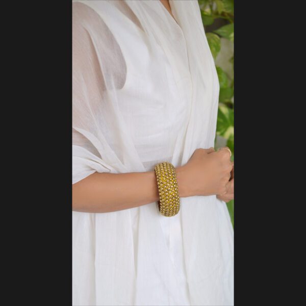 Wooden bangle with brass repousse