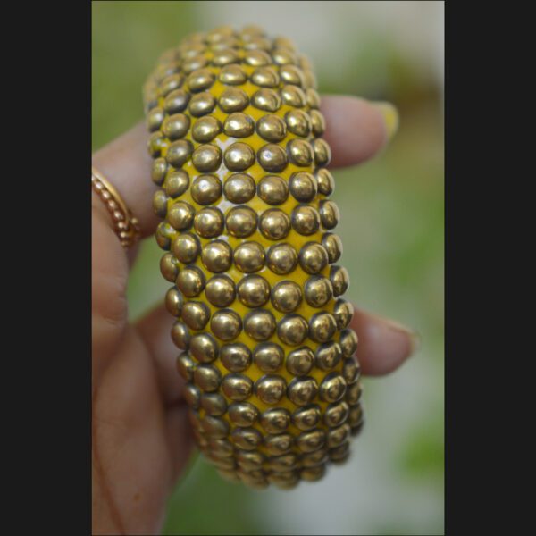 Wooden bangle with brass repousse