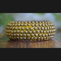 Wooden bangle with brass repousse