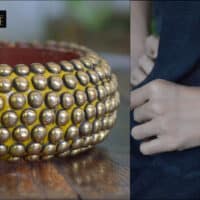 Wooden bangle with brass repousse